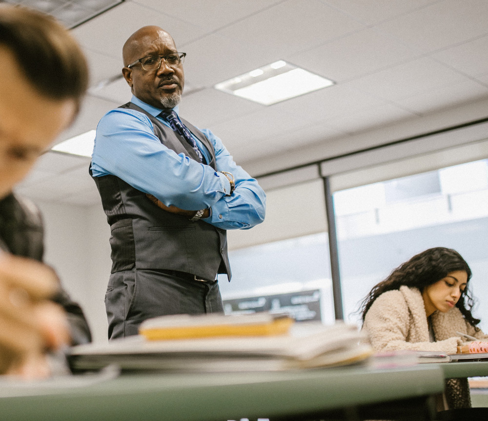 A teacher supervising students during an exam